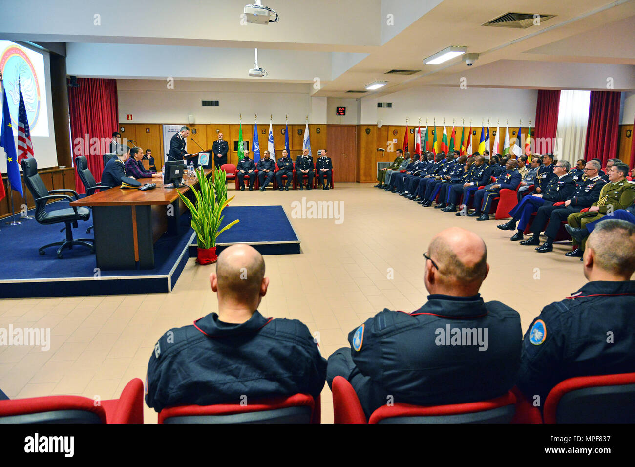 Commanding General, Brig. Gen. Giovanni Pietro Barbano (right), Center of Excellence for Stability Police Units (CoESPU) director, addresses dignitaries and guests from Europe, Africa, Italy and the U.S. during the Graduation Ceremony of the 14th Protection of Civilians Course at the CoESPU in Vicenza, Italy, Feb. 21, 2017. (U.S. Army Photo by Visual Information Specialist Paolo Bovo/released) Stock Photo