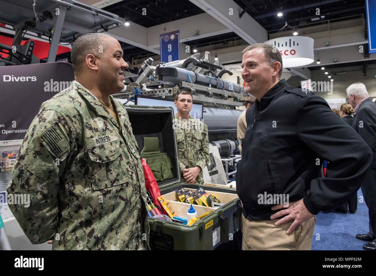 SAN DIEGO (Feb. 21, 2017) Rear Adm. Brian Brakke, right, Commander, Navy Expeditionary Combat Command (NECC), speaks to Logistics Specialist 2nd Class Vincent Intrieri at the NECC exhibit at WEST 2017. Now in its 27th year, WEST 2017 brings military and industry leaders together to engage with the makers of military platforms and the designers of today’s latest technologies. WEST 2017 is co-sponsored by AFCEA International and the U.S. Naval Institute. (U.S. Navy photo by Mass Communication Specialist 2nd Class Ellen Hilkowski) Stock Photo