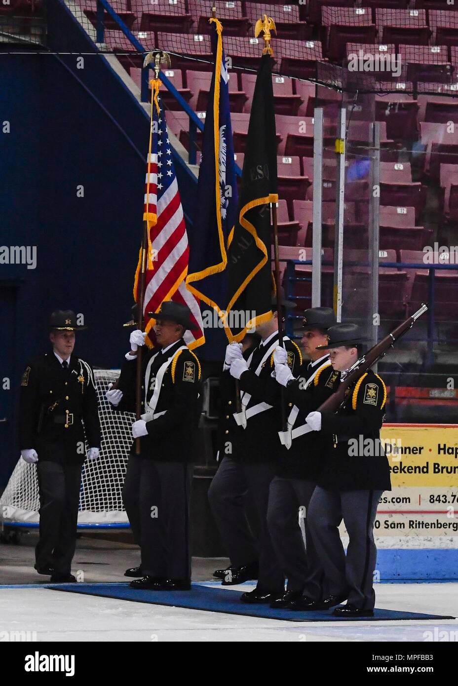 The Charleston County Sherriff’s office Honor Guard posts the colors beginning the 3rd Annual Matuskovic Charity Hockey Game at the North Charleston Coliseum & Performing Arts Center, Feb. 18, 2017. The game is played in memory of Joe Matuskovic, Charleston County Sherriff’s deputy, and other service members and first responders killed in the line of duty.(U.S. Air Force Photo/Airman 1st Class Megan Munoz) Stock Photo