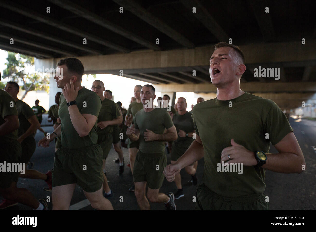 U.S. Marine Corps Cpl. Wesley Alexander, administrative specialist, with U.S. Marine Corps Forces, Pacific, calls cadence during the 33rd Annual Great Aloha Run in Honolulu, Hawaii, Feb. 20, 2017. Over 20,000 runners took part in the 8.15-mile run from the Aloha tower to the Aloha Stadium. (U.S. Marine Corps photo by Lance Cpl. Miguel A. Rosales) Stock Photo