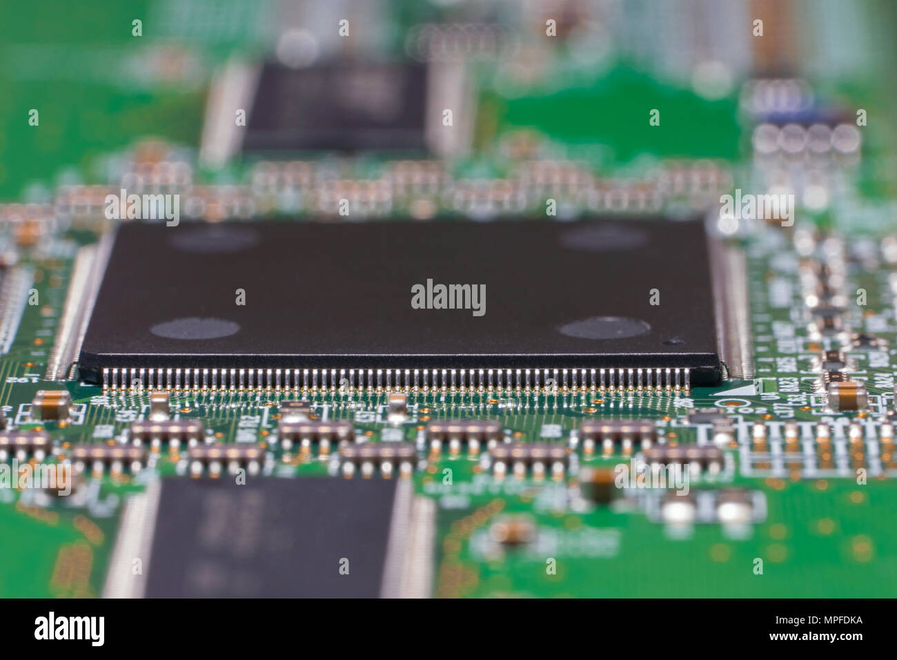 Printed circuit board with chips and SMD components. Macro photography of a fragment of a circuit Board of the electronic device Stock Photo