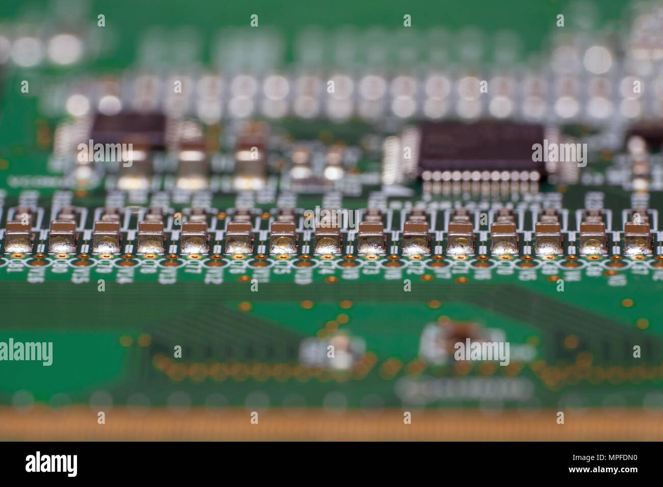 Printed circuit board with SMD capacitors close-up. Macro photography of a fragment of the decoder panel tft LCD monitor with installed electronic com Stock Photo