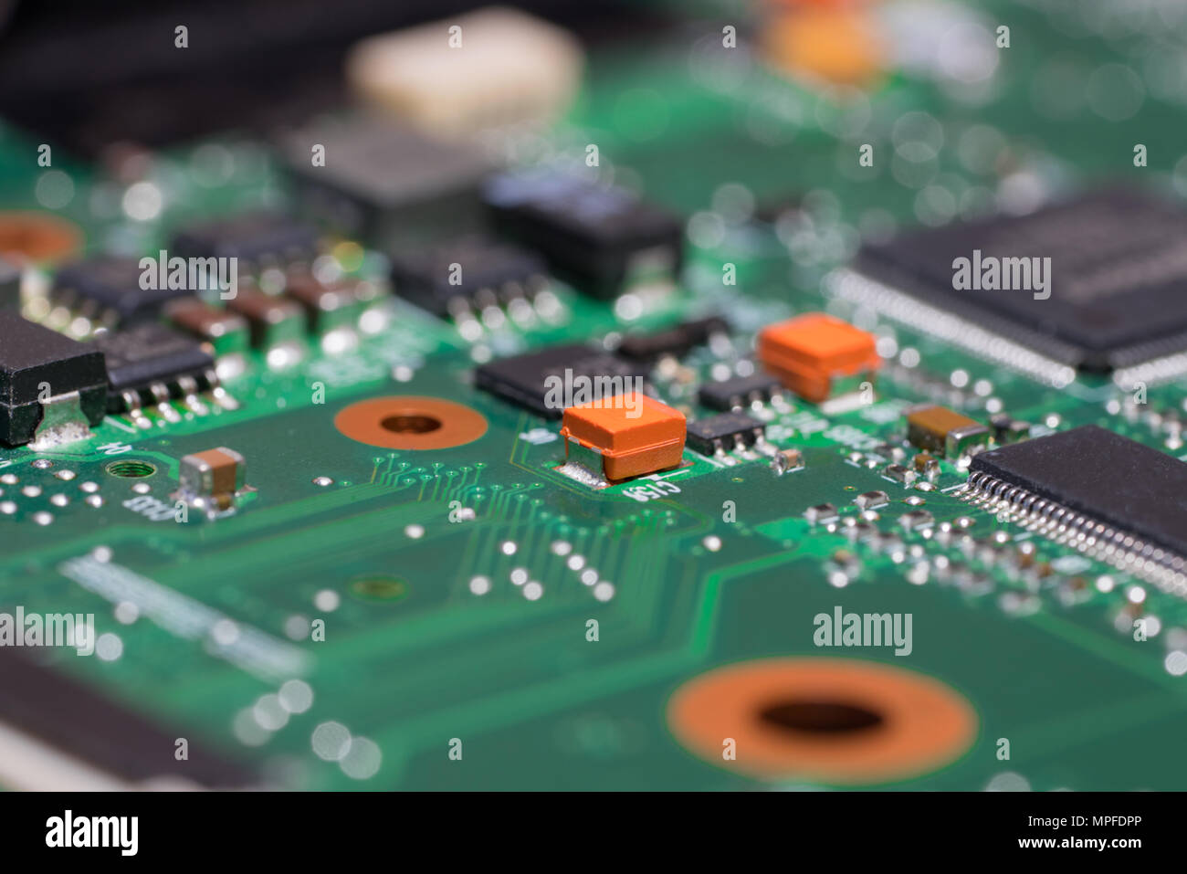 Laptop motherboard closeup. Printed circuit Board with SMD capacitors, resistors, diodes and chips. Stock Photo