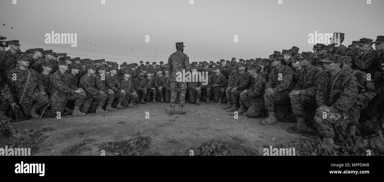 A Drill Instructor with Marine Corps Recruit Depot San Diego speaks to recruits about the Battle of Iwo Jima before the Eagle, Globe, & Anchor ceremony at Camp Pendleton, Calif., Feb. 23, 2017. Recruits with Delta Company, 1st Recruit Training Battalion, completed the Crucible and are scheduled to graduate on March 3, 2017. (U.S. Marine Corps photo by Cpl. Samantha K. Braun) Stock Photo