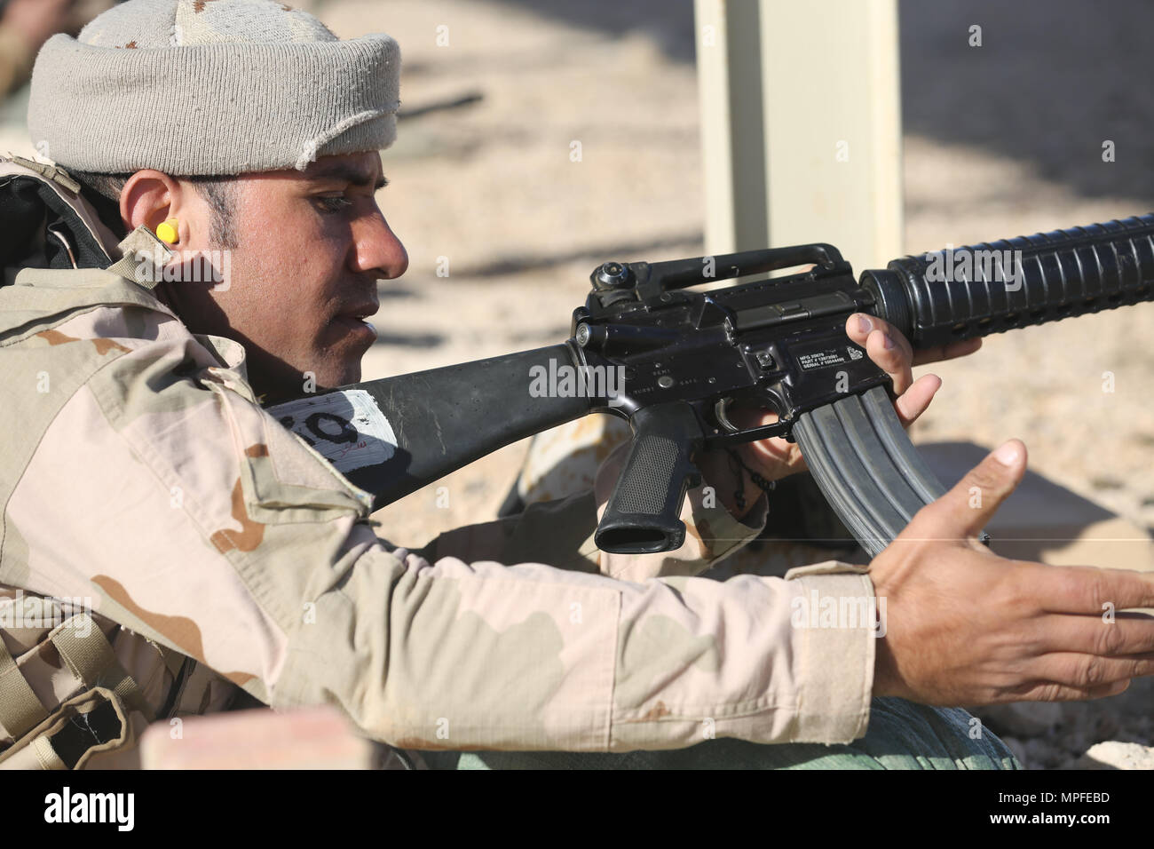 An Iraqi security forces soldier loads a magazine into his M16A2 rifle during weapons training at Al Asad Air Base, Iraq, Feb. 23, 2017.  This training is part of the overall Combined Joint Task Force – Operation Inherent Resolve building partner capacity mission to train and improve the capability of partnered forces fighting ISIS. CJTF-OIR is the global Coalition to defeat ISIS in Iraq and Syria. (U.S. Army photo by Sgt. Lisa Soy) Stock Photo