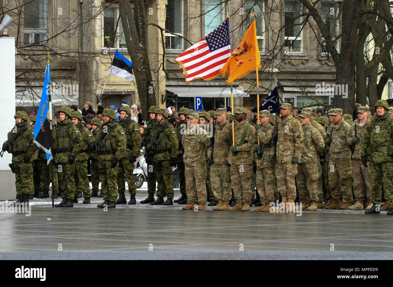 TALLINN, Estonia – Soldiers assigned to 1st Battalion, 68th Armor Regiment, 3rd Armored Brigade, 4th Infantry Division, stand in formation alongside Estonian soldiers at the Estonian Independence Day Parade in Tallinn, Estonia, Feb. 24, 2017. The 'Silver Lions' of 1-68 AR, on a training rotation in support of Operation Atlantic Resolve, showcased M1A2 Abrams tanks and M2A3 Bradley Fighting Vehicles and marched alongside host nation soldiers and NATO partners. Operation Atlantic Resolve is a U.S. led effort in Eastern Europe that demonstrates U.S. commitment to the collective security of NATO a Stock Photo