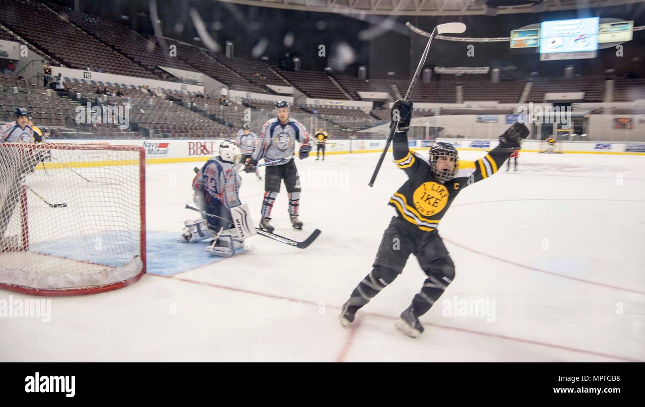 170225-N-KK394-078  NORFOLK, Va. (Feb. 25, 2017) Personnel Specialist 2nd Class Travis Cabe, a Sailor assigned to the aircraft carrier USS Dwight D. Eisenhower (CVN 69) (Ike), celebrates after scoring a goal during a benefit hockey game fundraising for the Navy-Marine Corps Relief Society at Scope Arena. Ike is currently pier side during the sustainment phase of the Optimized Fleet Response Plan (OFRP). (U.S. Navy photo by Mass Communication Specialist 3rd Class Anderson W. Branch) Stock Photo