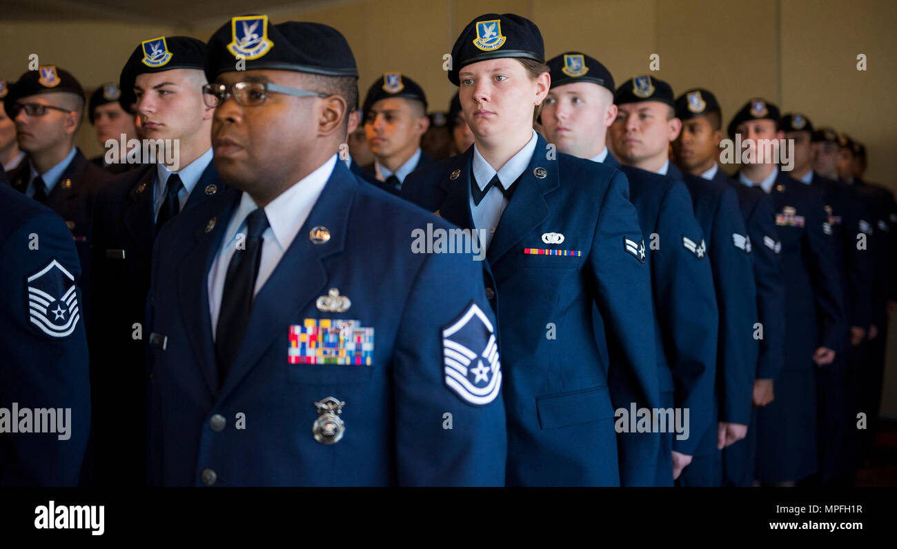 Airmen from the Security Forces Squadron stand at attention during the  National Anthem at a patrol boat dedication ceremony Feb. 24, 2017, at  Eglin Air Force Base, Florida. The boat is named