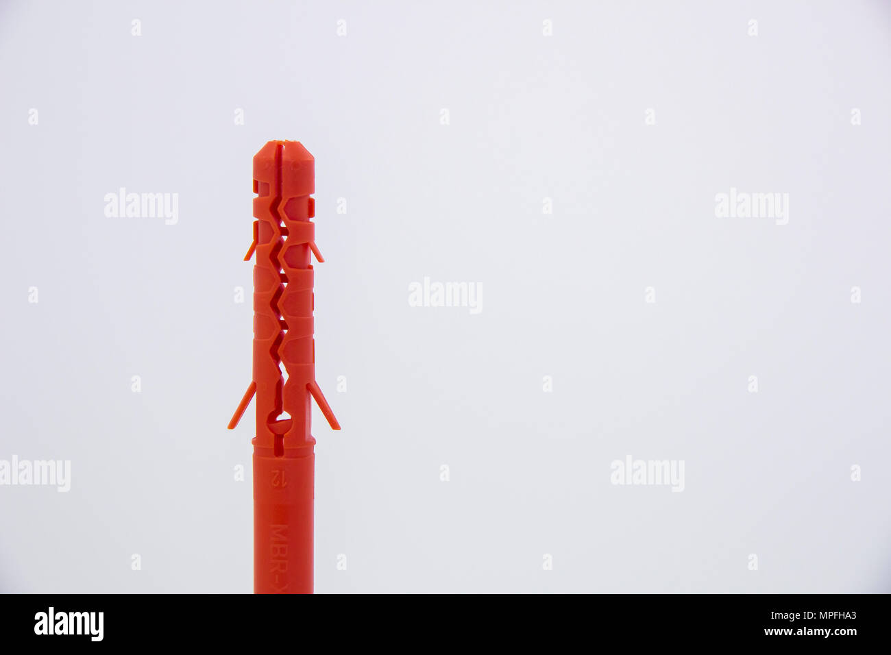 One plastic orange dowel on white background Stock Photo