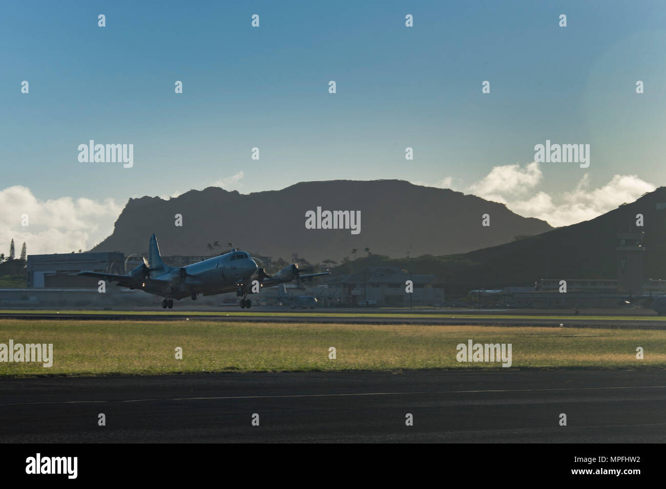 170303-N-YW024-006 KANEOHE BAY, HAWAII (Mar. 3, 2017) A P-3 Orion, assigned to Patrol Squadron Nine (VP-9) Golden Eagles, takes off during a command disestablishment at Marine Corps Base Hawaii. The VP-9  squadron was leaving for a scheduled deployment, to be followed by a homeport shift to Naval Air Station Whidbey Island in Washington. The P-3 Orion is a four-engine turboprop anti-submarine and maritime surveillance aircraft developed by the U.S. Navy in the 1960s. (U.S. Navy photo by Mass Communication Specialist 2nd Class Katarzyna Kobiljak) Stock Photo