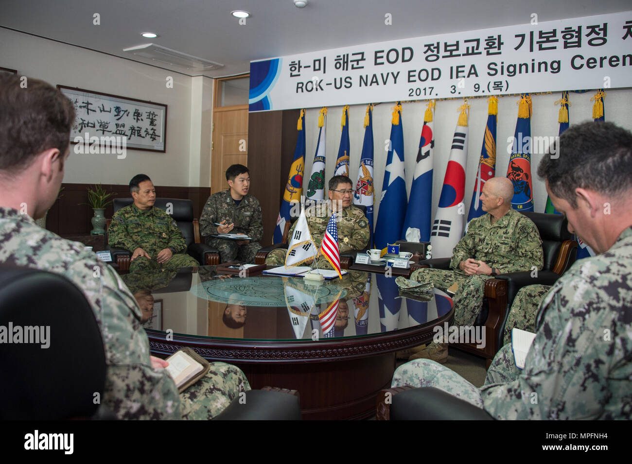 Commander, Task Force 75, U.S. Navy Capt. Robert A. Baughman, and Commander, Republic of Korea (ROK) Naval Special Warfare Flotilla, Rear Adm. Jae Eun Lee, speak during an information exchange agreement signing in Jinhae, ROK, March 9, 2017, as part of exercise Foal Eagle 2017. The agreement addresses research and development practices between the two nations, promotes explosive ordnance disposal interoperability, and enhances future readiness. (U.S. Navy Combat Camera photo by Mass Communication Specialist 3rd Class Alfred A. Coffield) Stock Photo