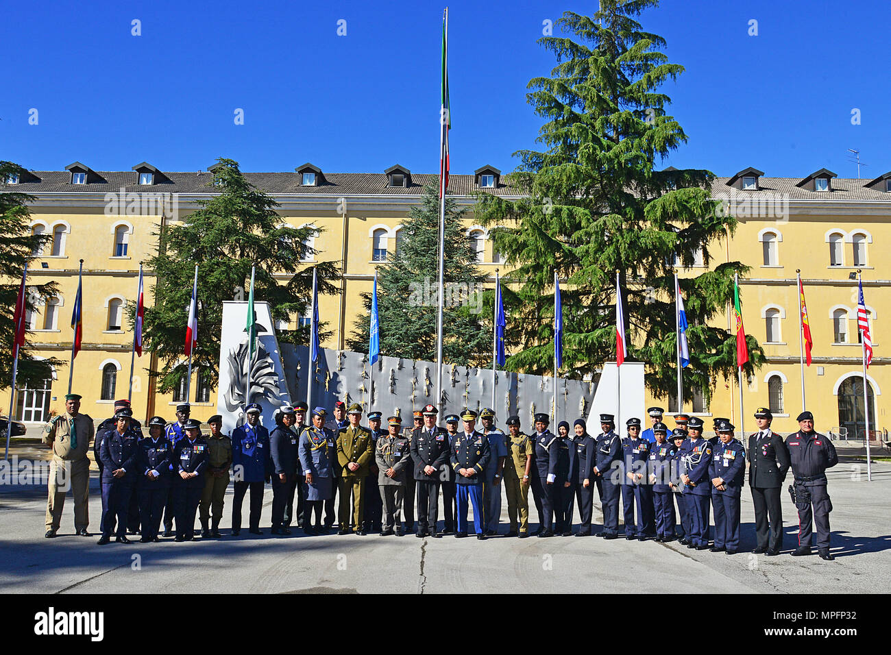 Brig. Gen. Giovanni Pietro Barbano (center), Center of Excellence for Stability Police Units (CoESPU) director, U.S. Army Col. Darius S. Gallegos, CoESPU deputy director and students from Europe, Africa, Italy and the U.S. pose for a group photo during the opening ceremony of the 5th “Gender Protection in Peace Operations” Course at the CoESPU in Vicenza, Italy, Mar. 8, 2017. (U.S. Army Photo by Visual Information Specialist Paolo Bovo/released) Stock Photo