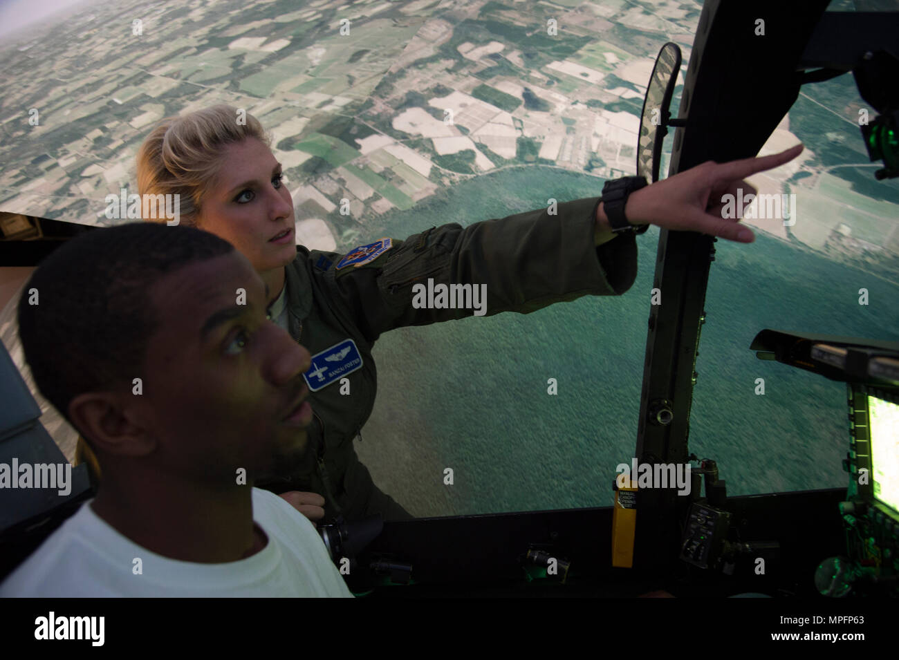 Capt. Kayla Foster, 74th Fighter Squadron A-10C Thunderbolt II pilot, gives instruction to Malcolm Mitchell, New England Patriots’ wide receiver and Super Bowl LI Champion, on operating the A-10 simulator during a visit March 7, 2017, at Moody Air Force Base, Ga. Mitchell, a Valdosta native, got a glimpse of a typical day in the life of Moody Airmen. Mitchell also spent time with Airmen and signed autographs for local Patriots’ fans during his visit. (U.S. Air Force photo by Andrea Jenkins) Stock Photo