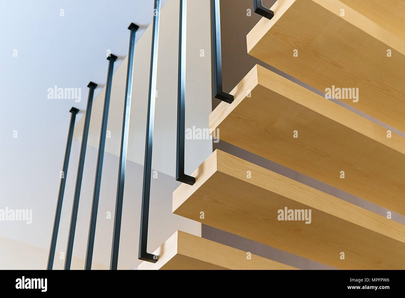 Floating stairs. Ash lumber stairs with metal railing attached to brown