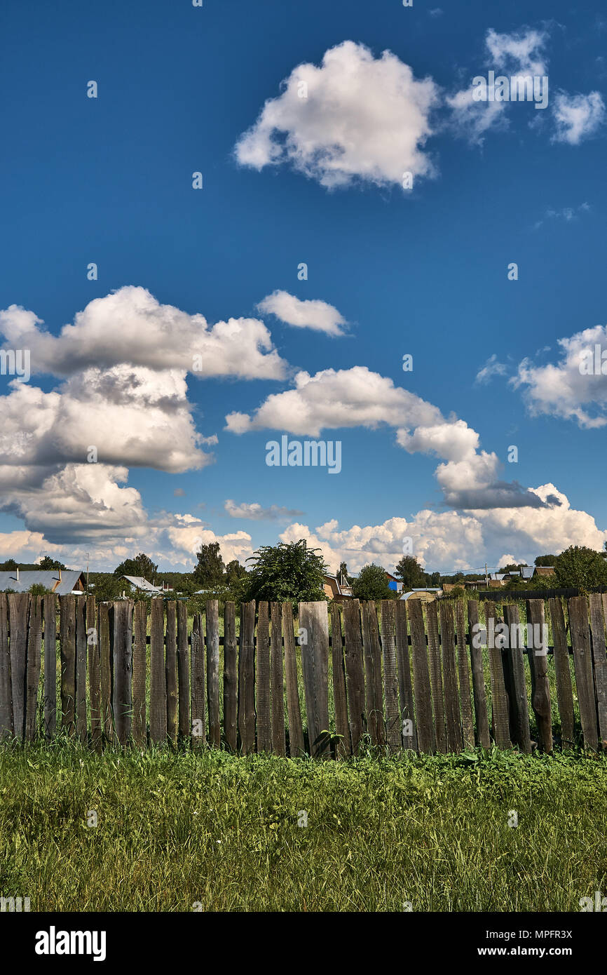Old wooden fence against the background of clouds in summer Stock Photo ...