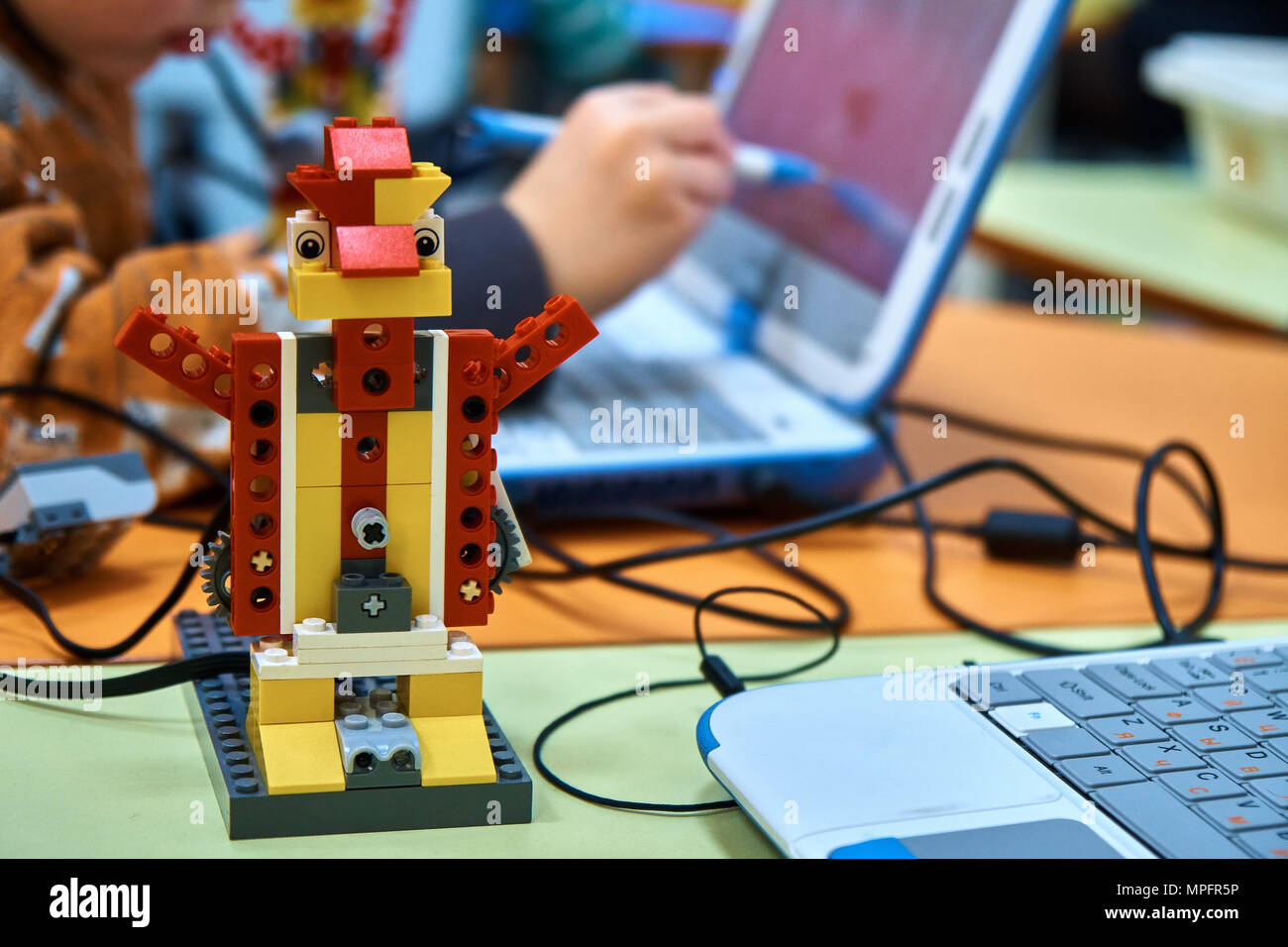 Robotic designer. Kids making and programming toy bricks machine on ...