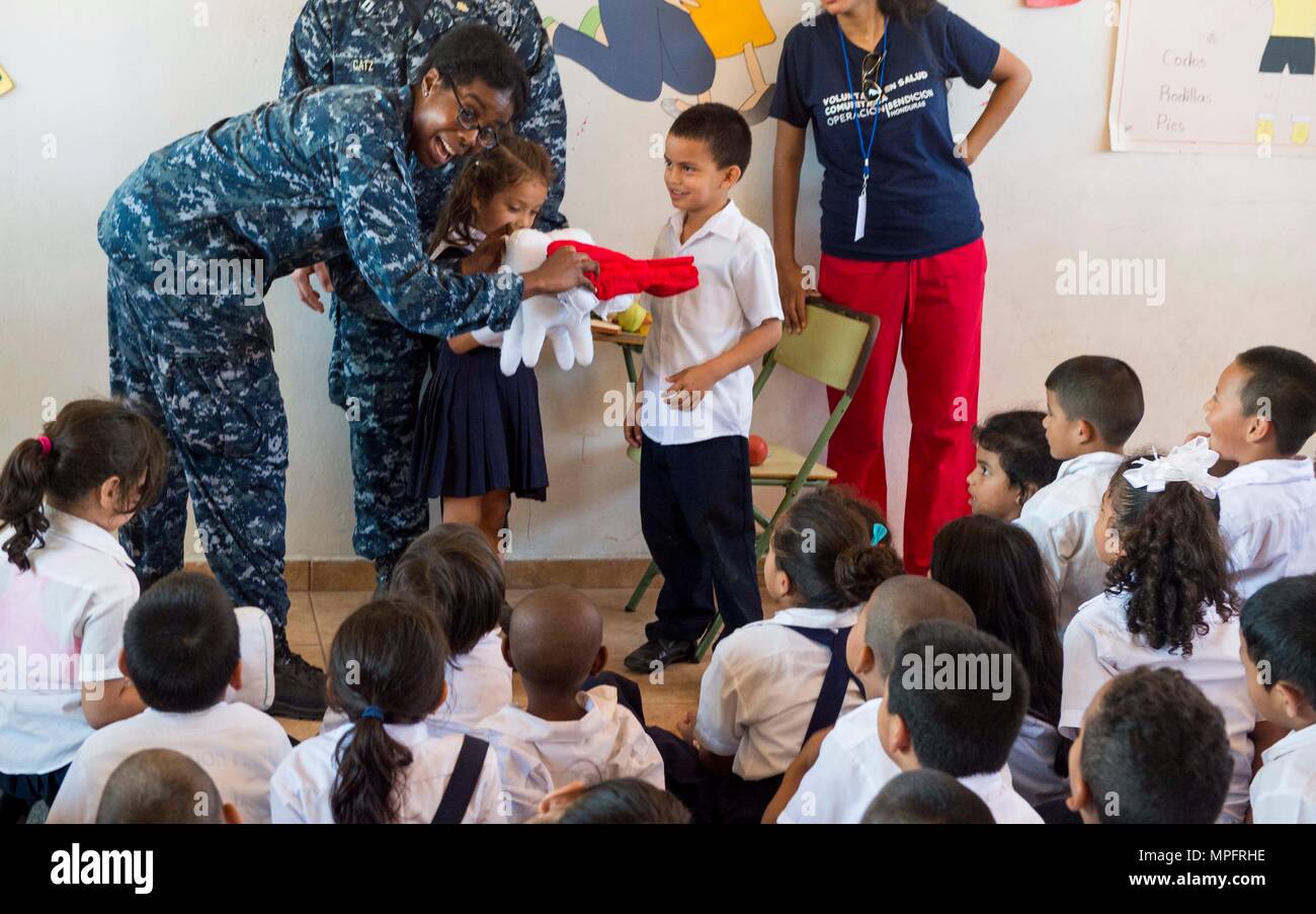 170227-N-YL073-498 TRUJILLO, Honduras (Feb. 27, 2017) – Hospital Corpsman 2nd Class Nicole Woodland, a native of Glen Burnie, Md., assigned to Walter Reed National Military Medical Center, Bethesda, teaches proper brushing techniques to Honduran school children in support of Continuing Promise 2017's (CP-17) visit to Trujillo, Honduras. CP-17 is a U.S. Southern Command-sponsored and U.S. Naval Forces Southern Command/U.S. 4th Fleet-conducted deployment to conduct civil-military operations including humanitarian assistance, training engagements, and medical, dental, and veterinary support in an Stock Photo