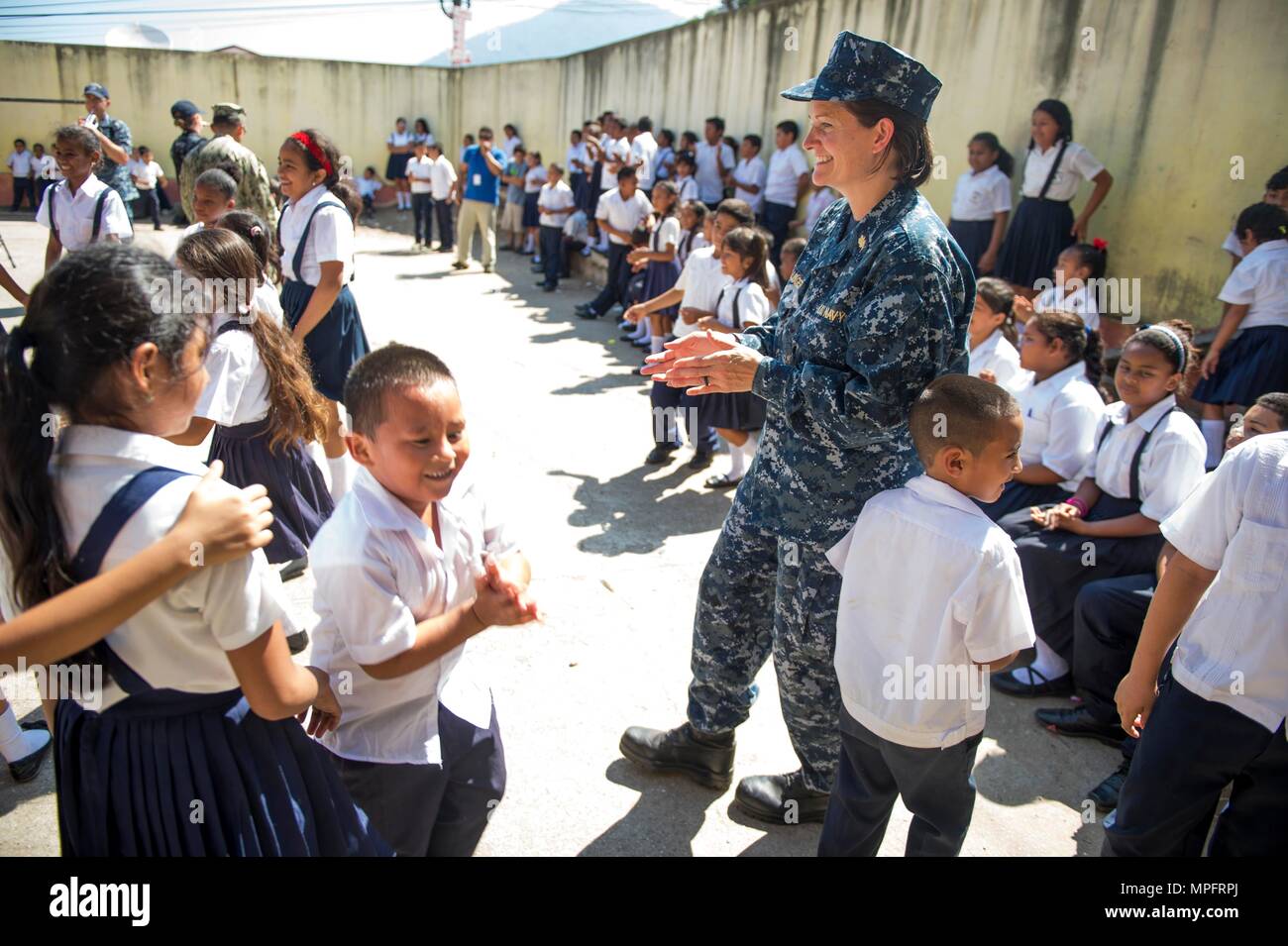 170227-N-YL073-356 TRUJILLO, Honduras (Feb. 27, 2017) Jennifer Wallinger, a dietitian assigned to Naval Hospital Jacksonville, Fla., dances with Honduran school children during Continuing Promise 2017 (CP-17) in Trujillo, Honduras. CP-17 is a U.S. Southern Command-sponsored and U.S. Naval Forces Southern Command/U.S. 4th Fleet-conducted deployment to conduct civil-military operations including humanitarian assistance, training engagements, and medical, dental, and veterinary support to Central and South America. (U.S. Navy photo by Mass Communication Specialist 2nd Class Shamira Purifoy/Releas Stock Photo