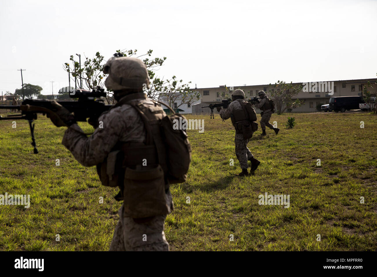 Marines rush a simulated enemy firing position at Naval Station Guantanamo Bay, Cuba, April 9, 2017. The Marines were participating in battle drills to practice squad movement and unit integrity. The Marines are with 3rd Battalion, 2nd Marine Regiment. Stock Photo
