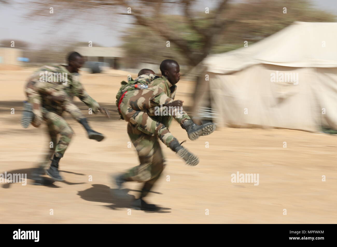 Nigerien soldiers practice buddy carry techniques during a first aid class as part of Flintlock
