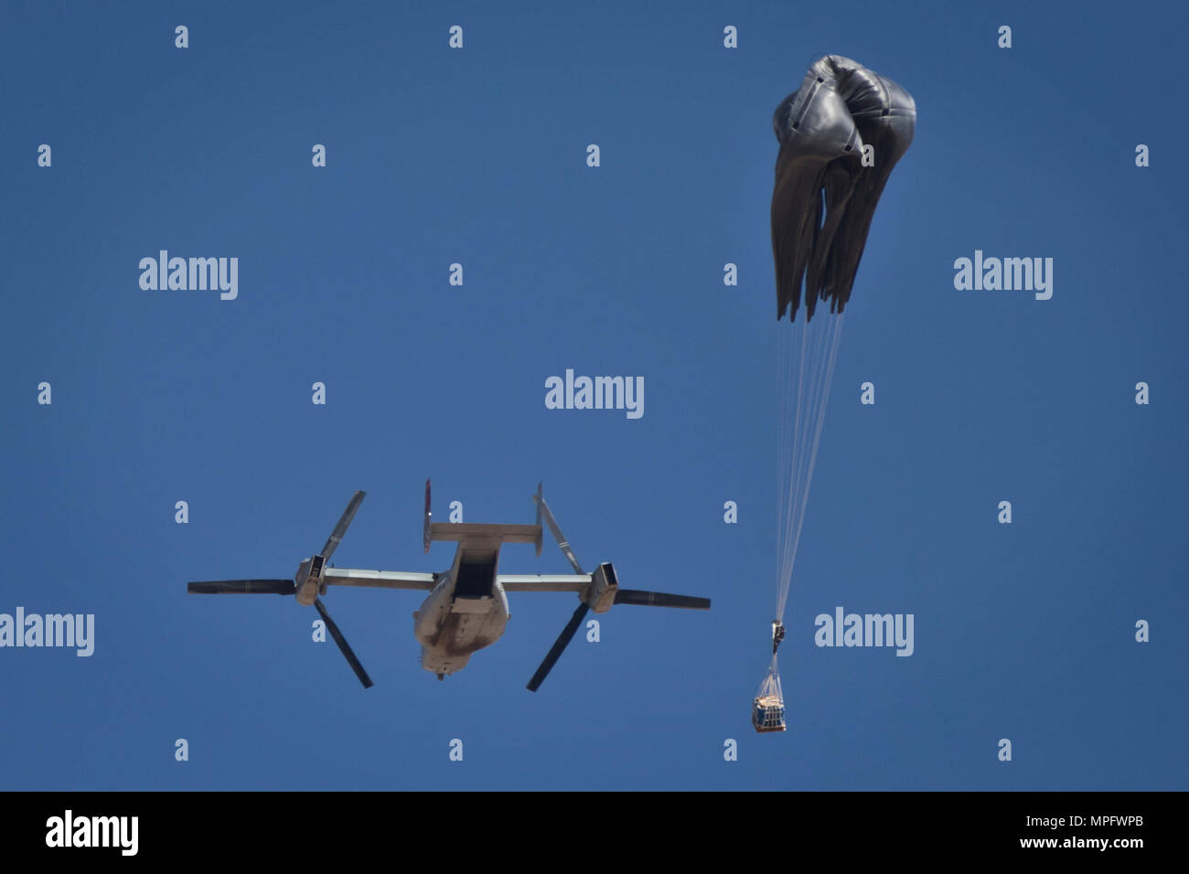 A container delivery system (CDS) airdrops out the back of a Marine