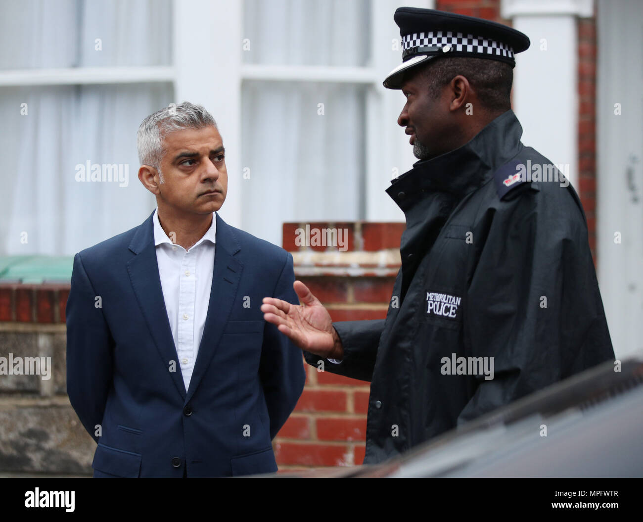 Mayor of London, Sadiq Khan (left), is briefed by Ade Adelekan from the Metropolitan Police's new Violent Crime Taskforce, during a dawn raid with police officers targeting an individual believed to be connected to drug dealing and violent crime, in north London. The Violent Crime Taskforce comprises of uniformed officers, borough, territorial support, City of London officers, plain clothes officers and the dog unit. Stock Photo