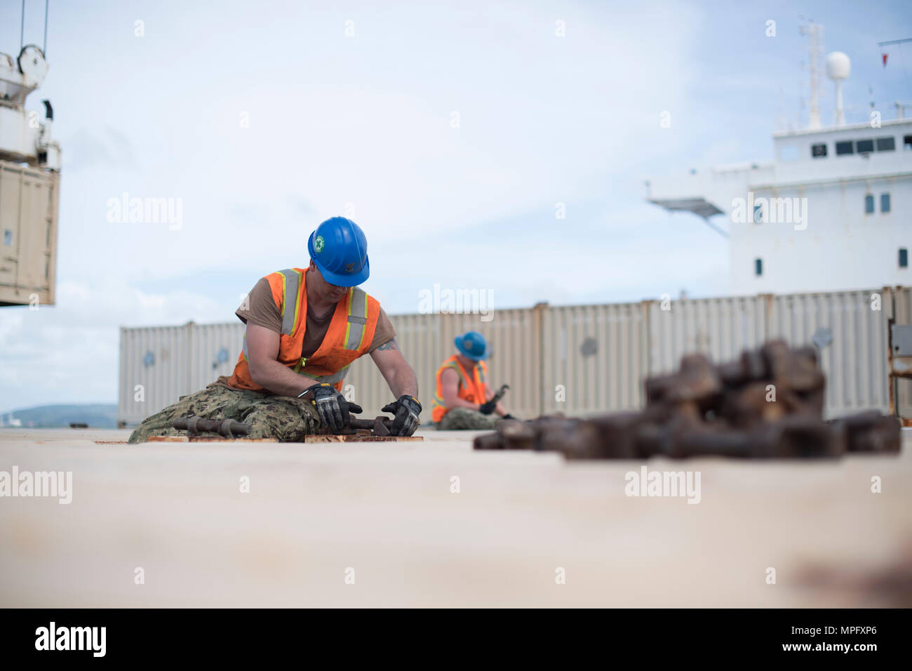 Deployable Logistics Sailors from Navy Cargo Handling Battalion 1 load cargo aboard MV Major ...