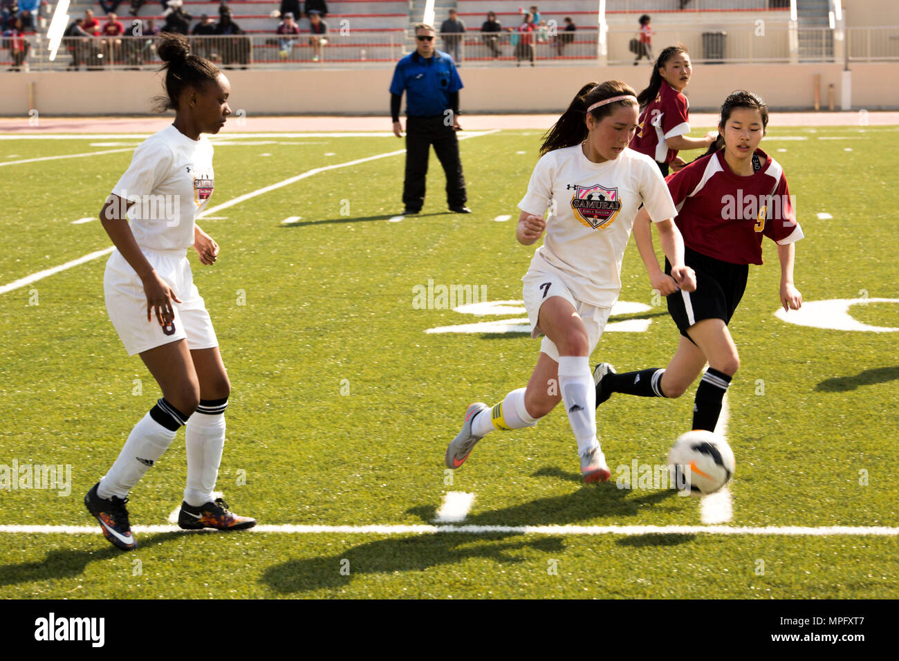 A Player On The Matthew C Perry Lady Samurai Soccer Team Competes Against A Player From Marist Brothers International School During The Western Japan Athletic Association Girls Soccer Tournament On M C Perry