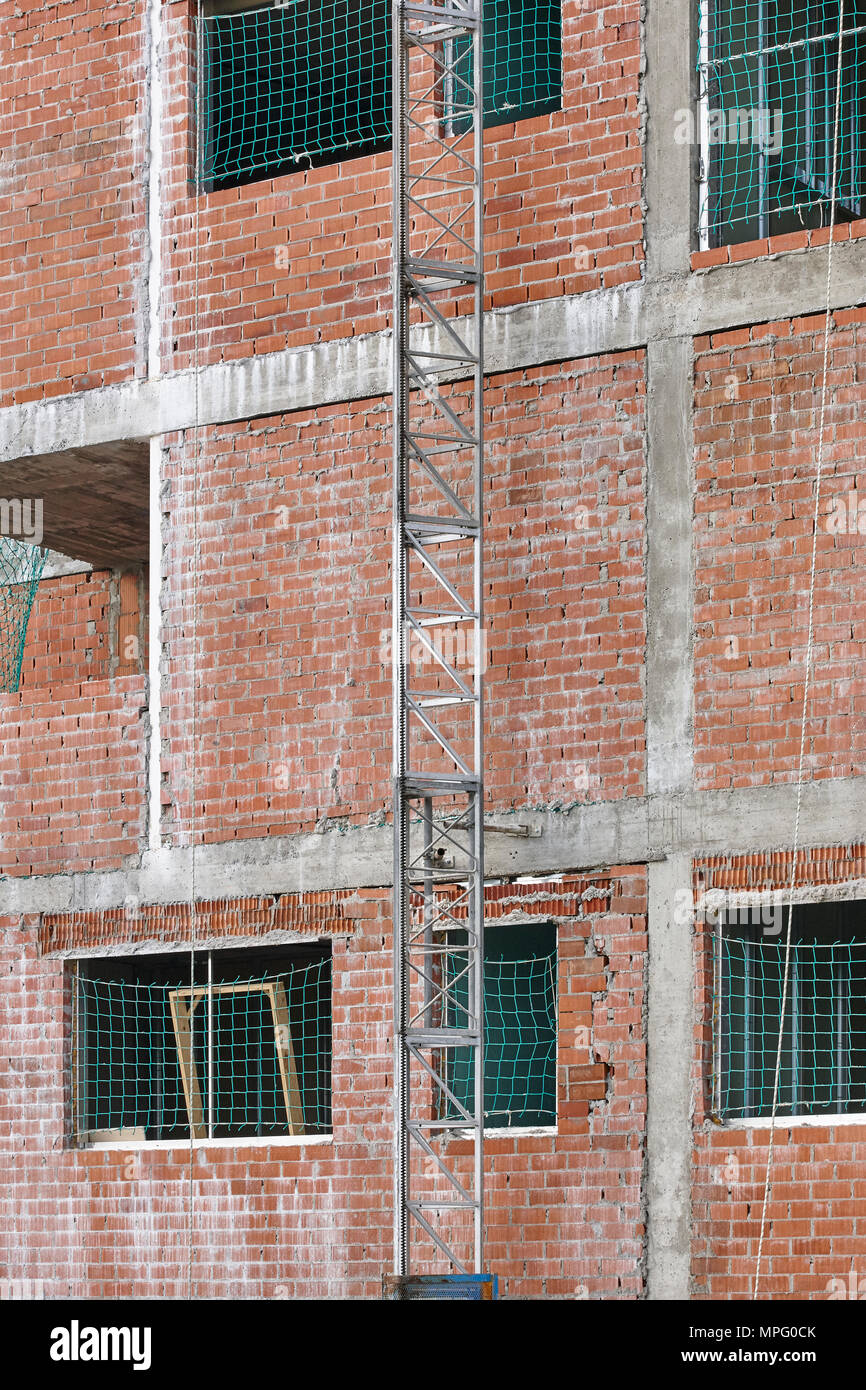 Building under construction. Brick facade structure. Architecture ...