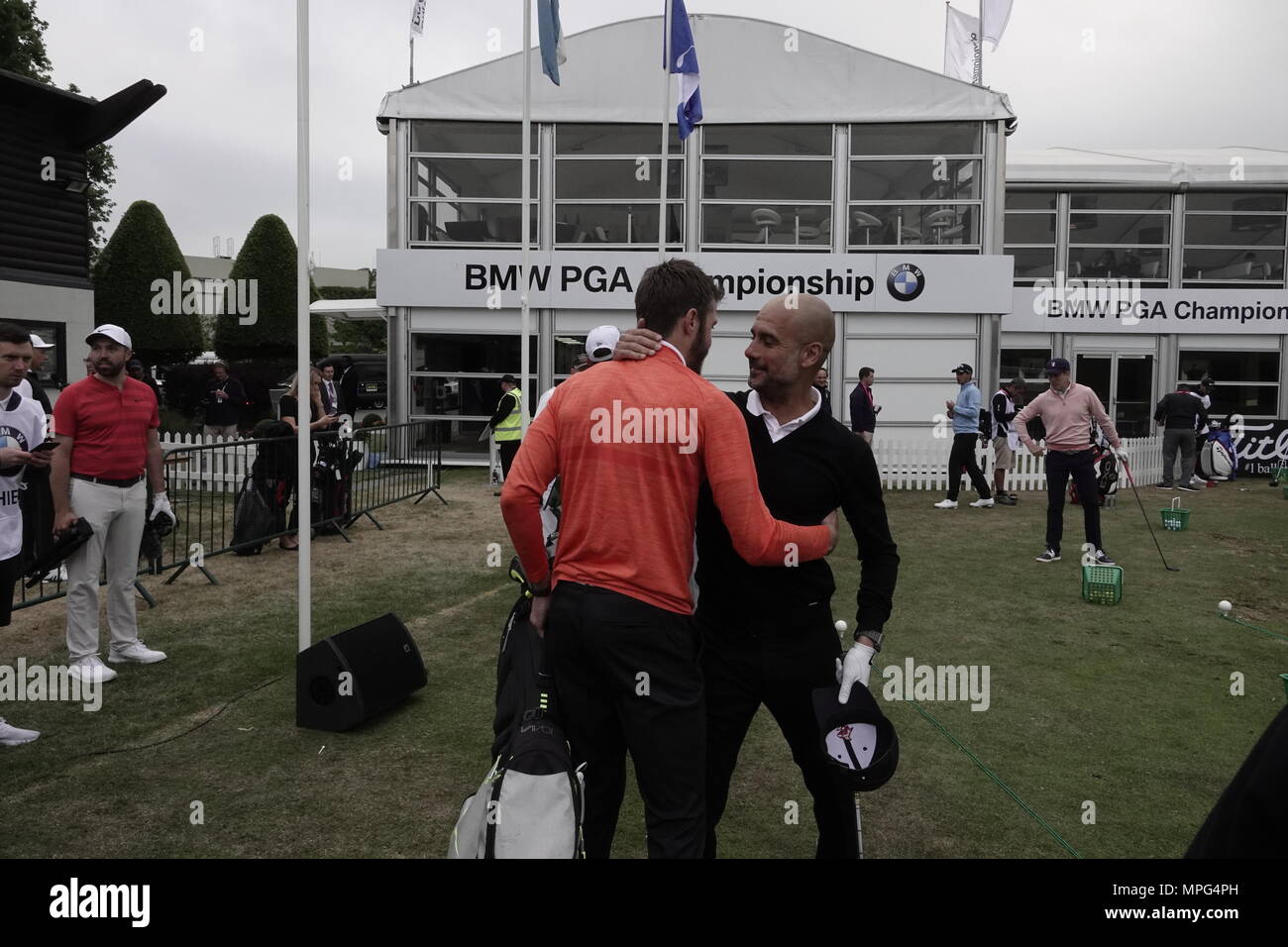 Wentworth, Surrey, UK., 23rd May, 2018  Michael Carrick, Manchester United player, greets fierce rival Manchester City boss Pep Guardiola as they arrive on the range at the BMW.PGA ProAM golf Championship. Credit: Motofoto/Alamy Live News Stock Photo