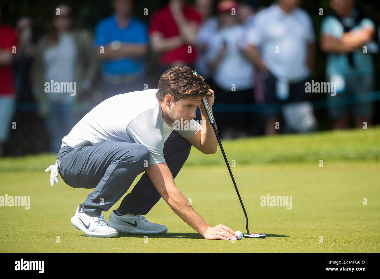 Wentworth Club, Virginia Water, UK. 23rd May, 2018. BMW PGA Championship at Wentworth, Pro AM day; Nial Horen lines up his putt on the first green Credit: Action Plus Sports/Alamy Live News Stock Photo