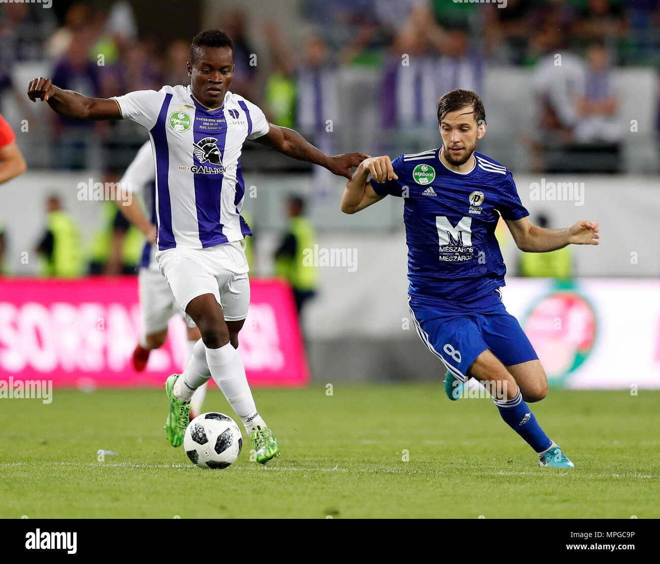 Budapest, Hungary. 23rd May, 2018. (l-r) Vincent Onovo of Ujpest FC wins  the ball from David Markvart of Puskas Akademia FC during the Hungarian Cup  Final match between Puskas Akademia FC and