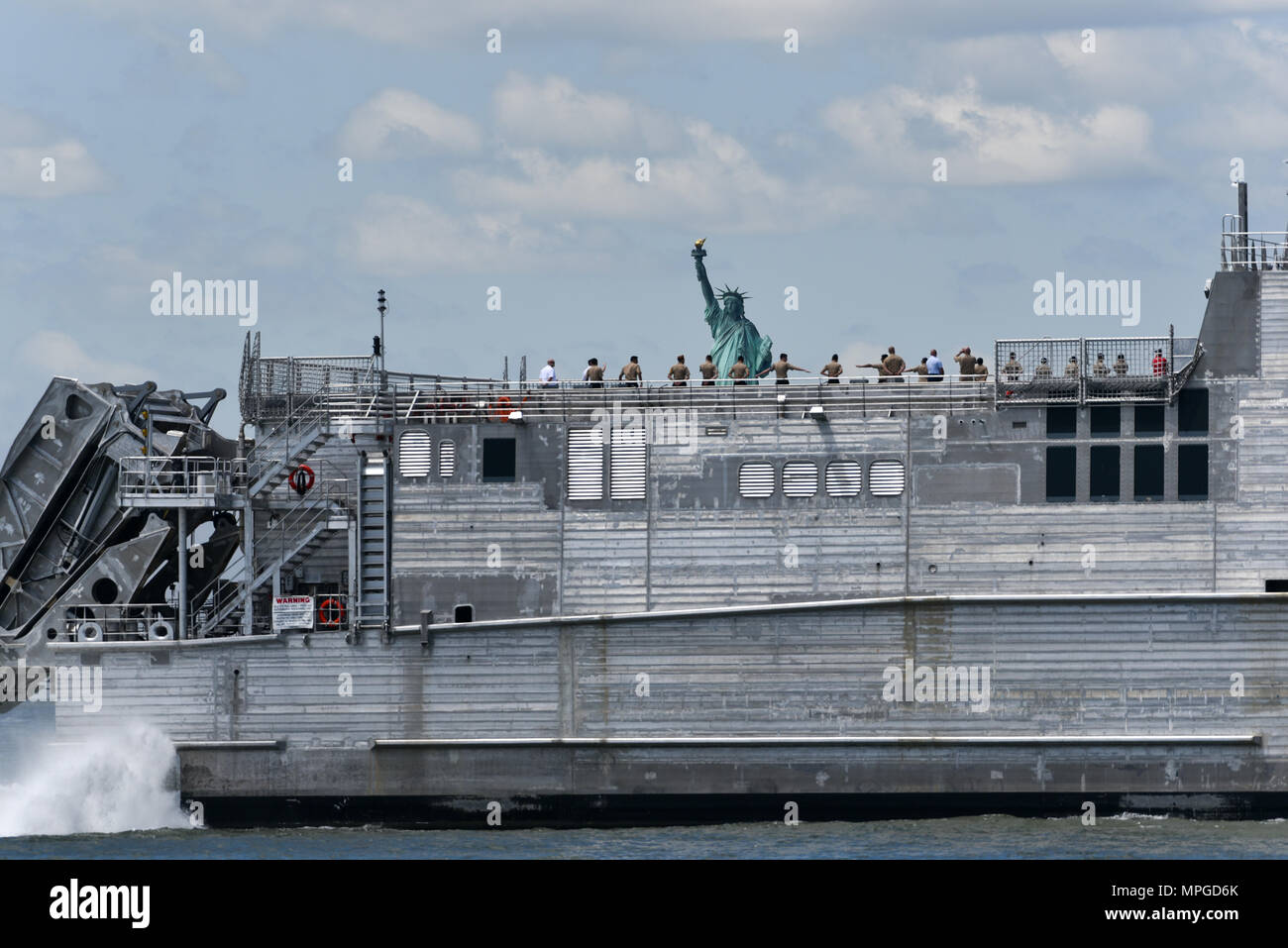 New York, USA. 23rd May, 2018. The USNS City of Bismarck joins the Parade of Ships as it makes its way past the Statue of Liberty on the opening day of Fleet Week on May 23, 2018 in New York City. Credit: Erik Pendzich/Alamy Live News Stock Photo