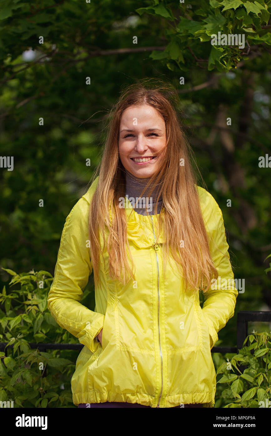 Portrait of beautiful smiling girl against green park Stock Photo - Alamy