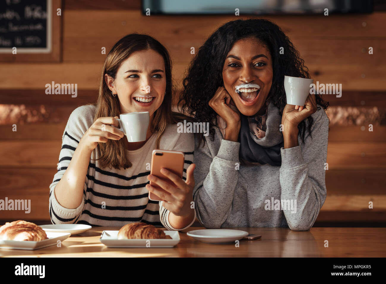 Two women and drinking coffee hires stock photography and images Alamy