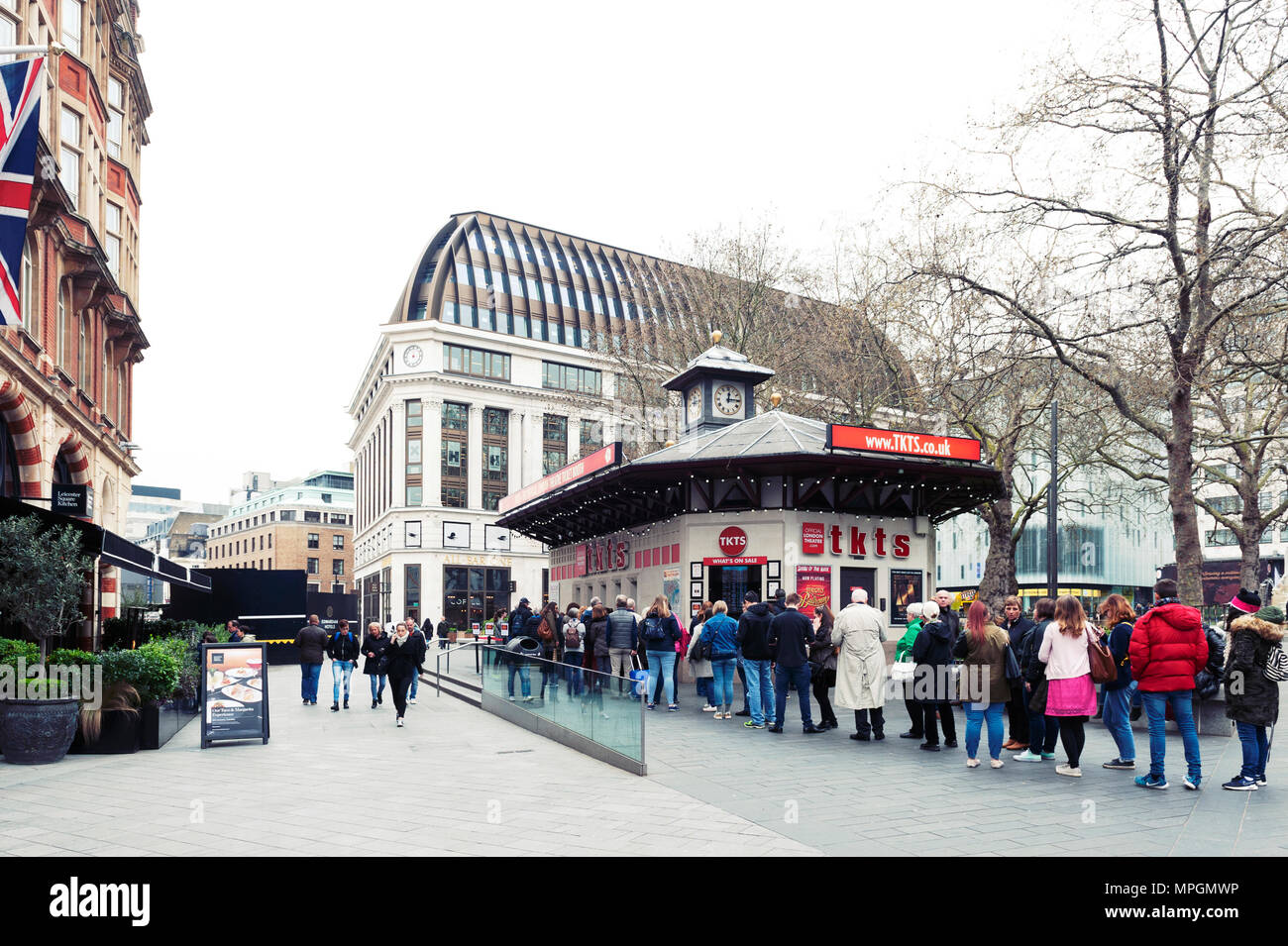 London, UK - April 2018: People queue for buying tickets from TKTS, the official London theatre ticket booth located at Leicester Square Stock Photo