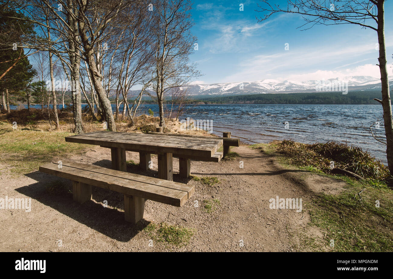 Table and bench on the shore of the lake, Aviemore, Scotland. Stock Photo