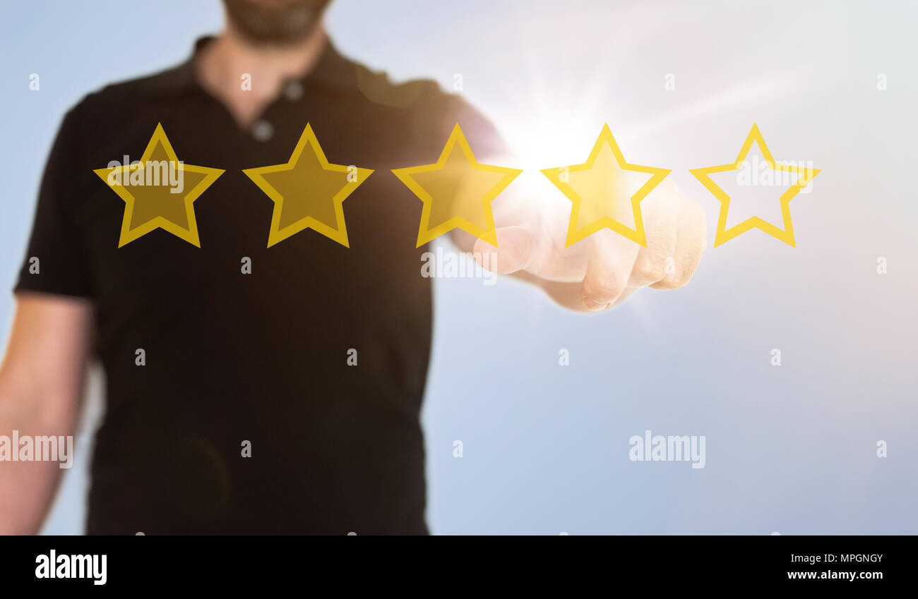 businessman touching translucent touch screen interface with golden rating stars Stock Photo