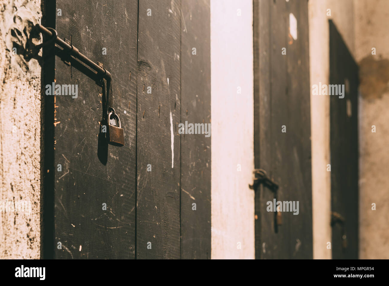 Close up view of iron lock on an weathered wooden door Stock Photo - Alamy