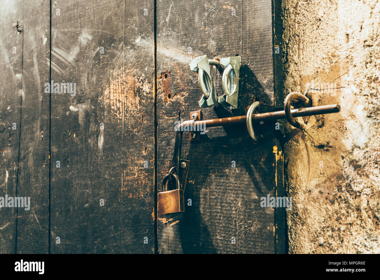 Close up view of iron lock on an weathered wooden door Stock Photo - Alamy