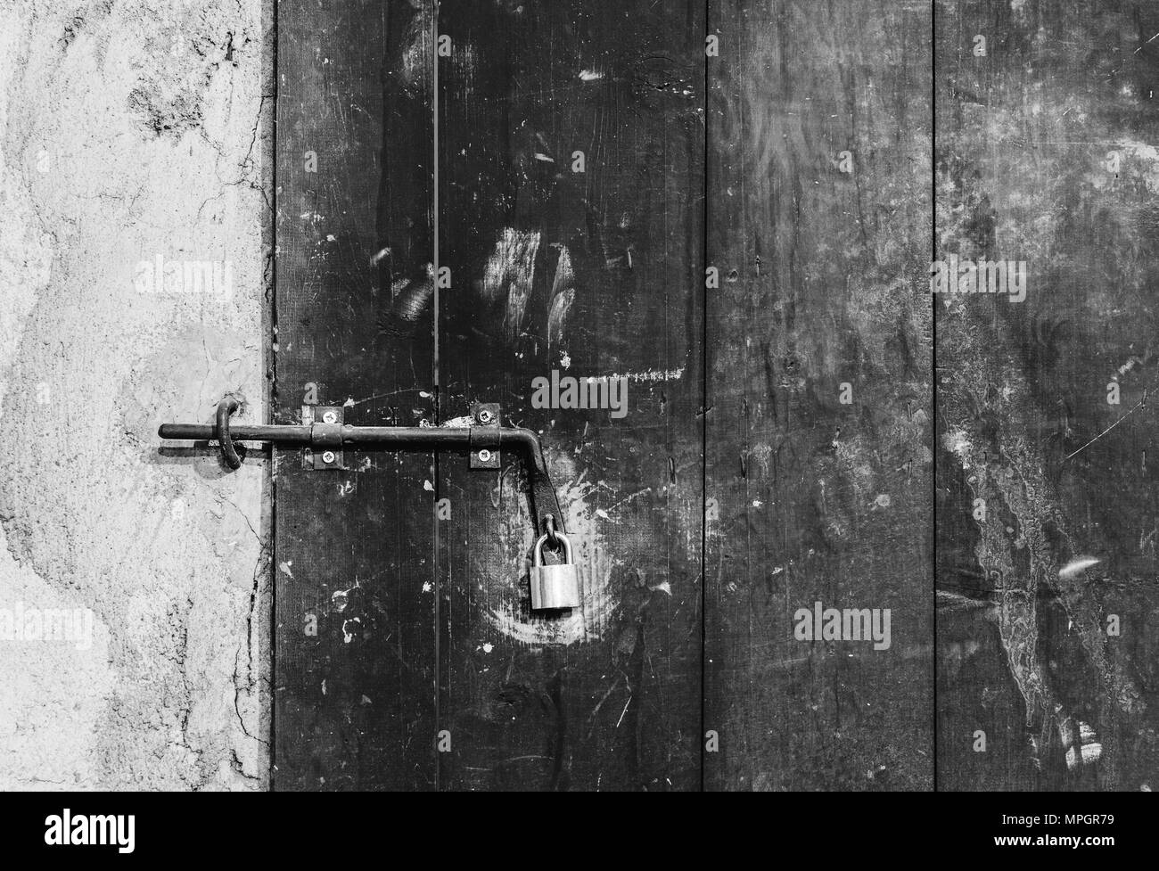 Close up view of iron lock on an weathered wooden door. Stock Photo