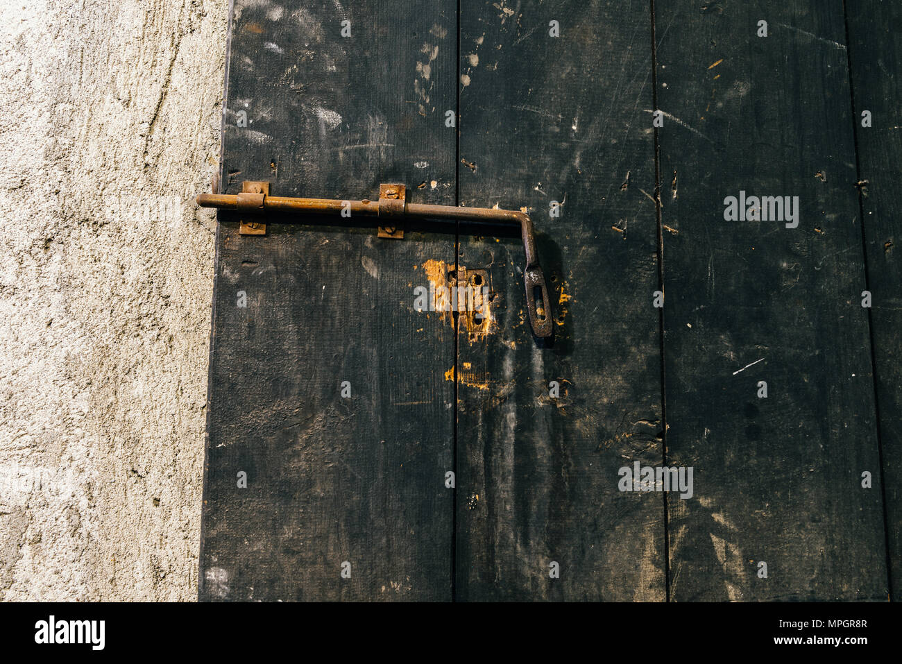 Close up view of iron lock on an weathered wooden door Stock Photo - Alamy