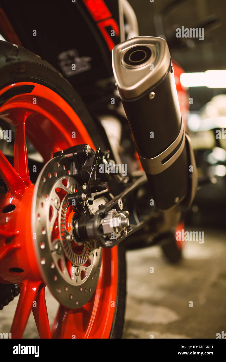 Detail of the exhaust pipe of a motorbike in a workshop Stock Photo