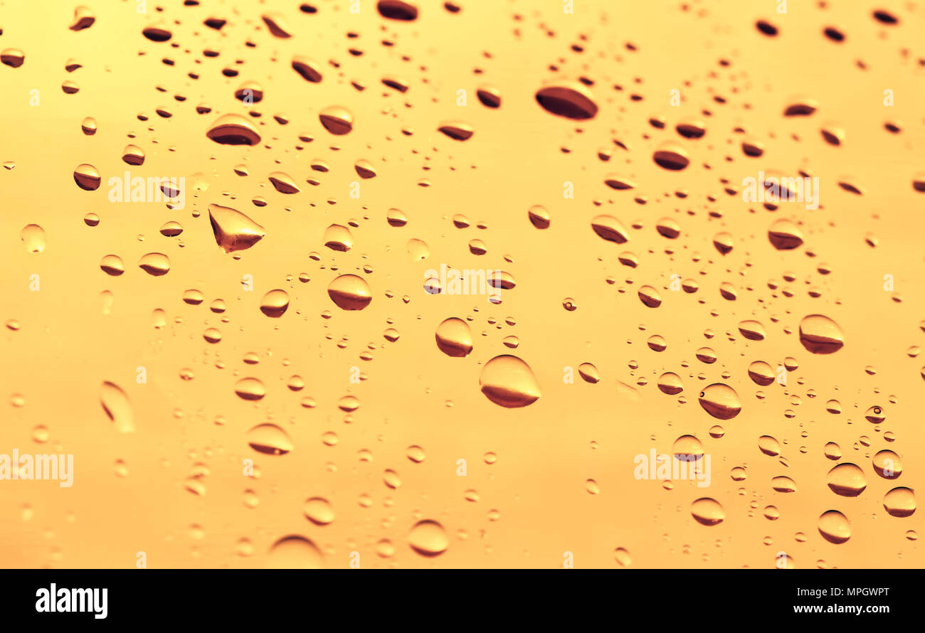 water drops on a golden background Stock Photo - Alamy