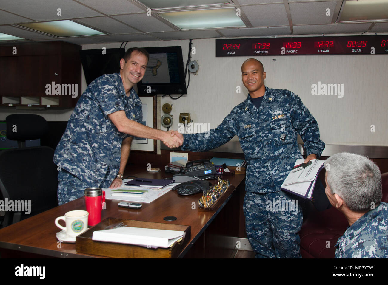 SANTA RITA, Guam - The submarine tender USS Frank Cable (AS 40) Commanding Officer Capt. Drew St. John congratulated Chief Damage Controlman Cyprus V. Abundo, native of Angeles City, Philippines, for his selection as the winner of the 2016 GEICO Military Service Award - Fire Safety and Prevention, Feb. 10.  Frank Cable, forward deployed to the island of Guam, conducts maintenance and support of submarines and surface vessels deployed to the U.S. 5th and 7th Fleet area of operations.  (U.S. Navy photo by Mass Communication Specialist 3rd Class Alana Langdon/Released) Stock Photo