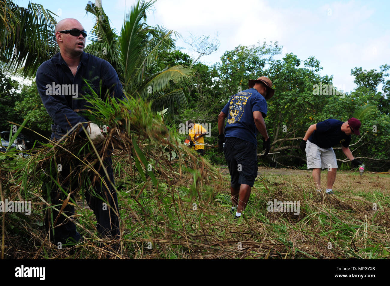 170225-N-WA347-159  PITI, Guam (Feb. 25, 2017) - First class petty officers and chief petty officers, assigned to the submarine tender USS Frank Cable (AS 40), clean up around the Atantano Shrine in Piti, Guam Feb. 25, during a CPO 365 community relations project.  Frank Cable is forward deployed to the island of Guam and conducts maintenance and support of submarines and surface vessels deployed to the U.S. 5th and 7th Fleet area of operations.  (U.S. Navy photo by Mass Communication Specialist 1st Class Eva-Marie Ramsaran/Released) Stock Photo