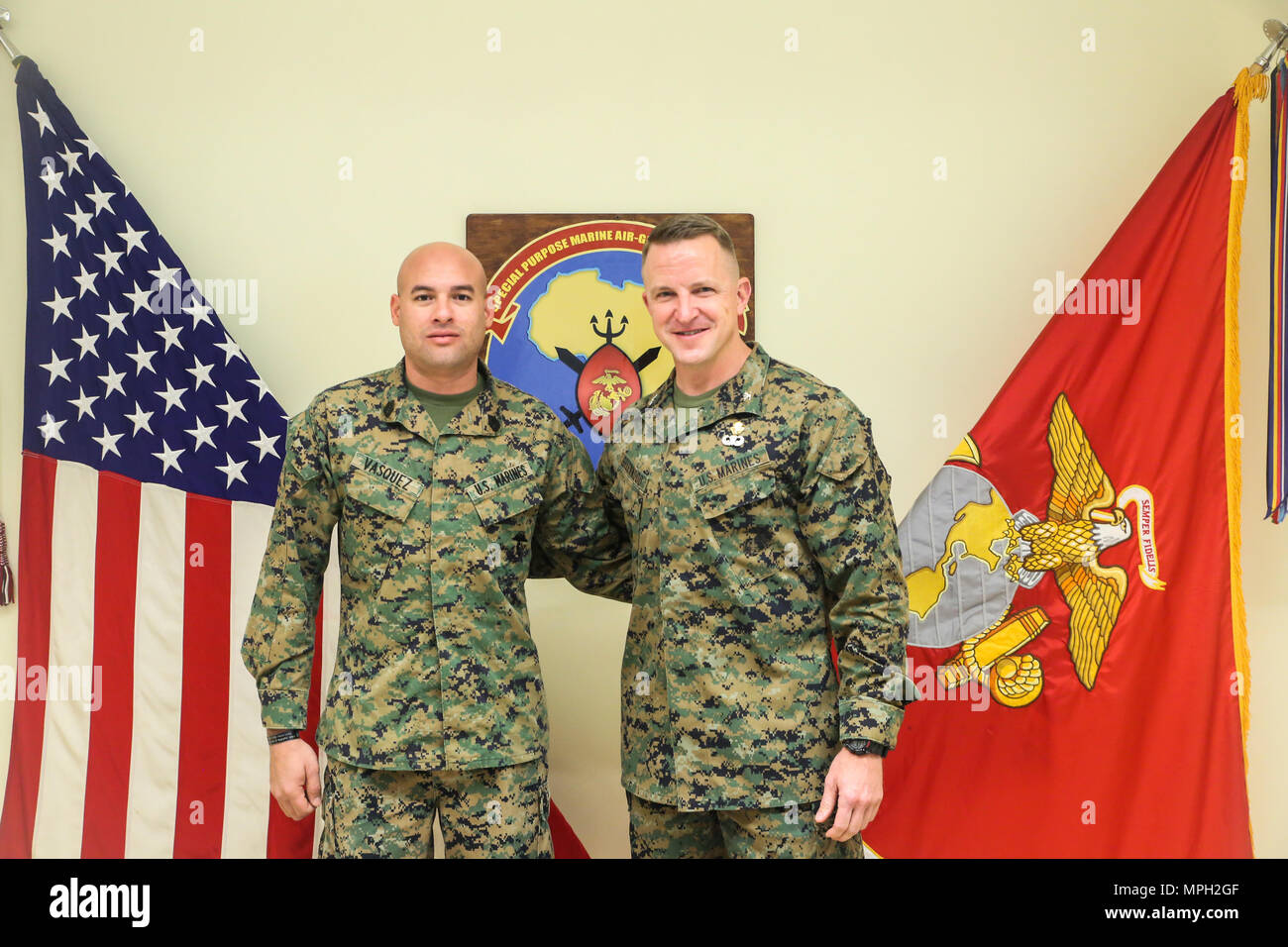 Gunnery Sgt. Juan Vasquez Jr., a U.S. Marine assigned to Special Purpose Marine Air-Ground Task Force – Crisis Response – Africa, poses for a photo with Col. Daniel Greenwood, the commanding officer of SPMAGTF-CR-AF, at Naval Air Station Sigonella, Italy, Feb. 25, 2017. Greenwood formerly served as the commanding officer for Marine Corps Recruiting Station Fort Lauderdale, Florida, while Vasquez was a poolee for the station in 2003. (U.S. Marine Corps photo by Cpl. Samuel Guerra/Released) Stock Photo