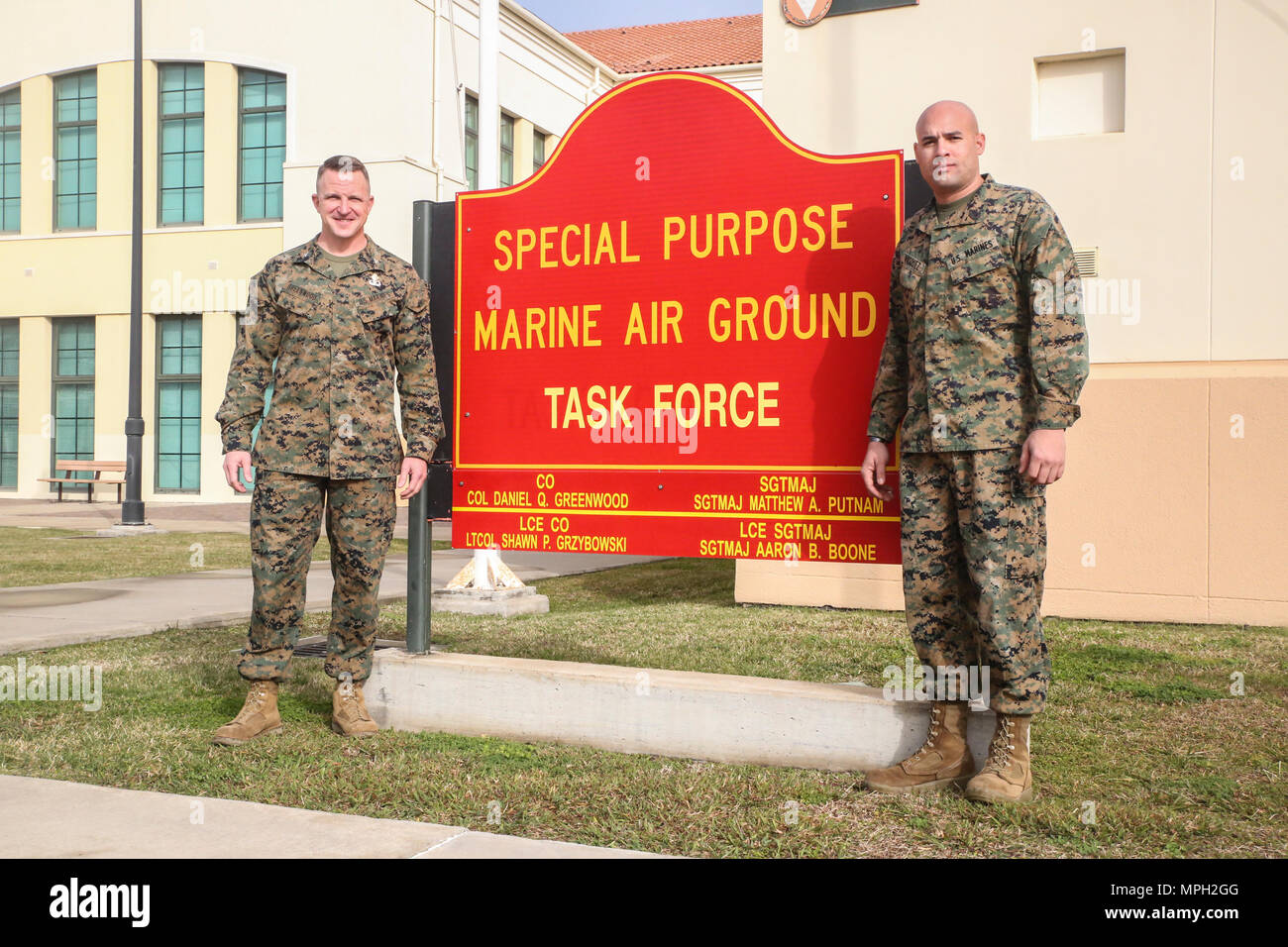 Gunnery Sgt. Juan Vasquez Jr., a U.S. Marine assigned to Special Purpose Marine Air-Ground Task Force – Crisis Response – Africa, right, poses for a photo with Col. Daniel Greenwood, the commanding officer of SPMAGTF-CR-AF, at Naval Air Station Sigonella, Italy, Feb. 25, 2017. Greenwood formerly served as the commanding officer for Marine Corps Recruiting Station Fort Lauderdale, Florida, while Vasquez was a poolee for the station in 2003. (U.S. Marine Corps photo by Cpl. Samuel Guerra/Released) Stock Photo