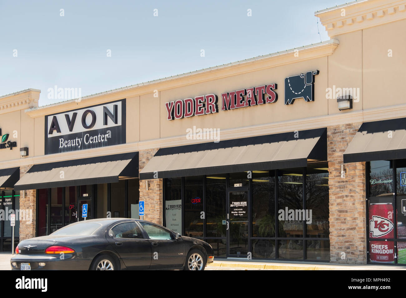 A strip mall containing a butcher shop or meat market, and Avon Beauty Center in Wichita, Kansas, USA. Stock Photo