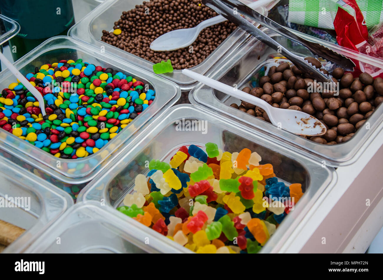 A sample of several candies in plastic containers Stock Photo